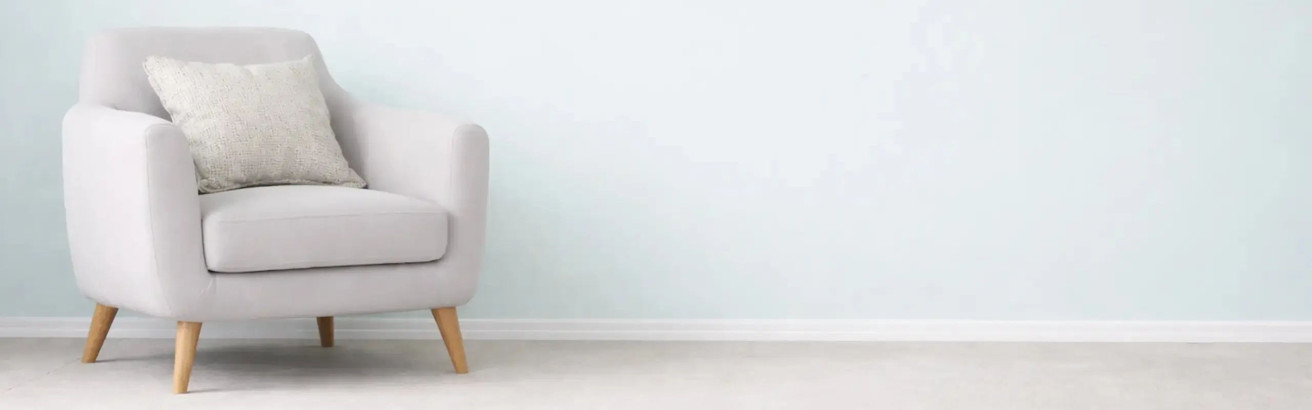 Bright, minimal therapy room with armchair and soft lighting